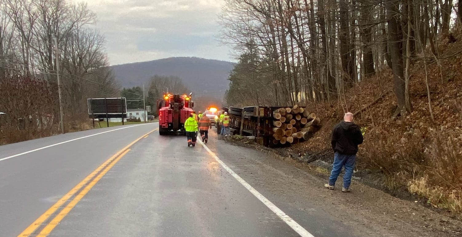 Large truck carrying logs crashes, narrowly misses school bus Large truck carrying logs crashes, narrowly misses school bus