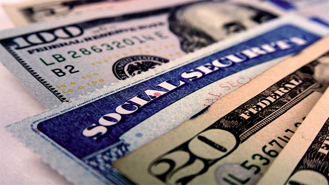 social security cards with cash representing social security benefits in retirement