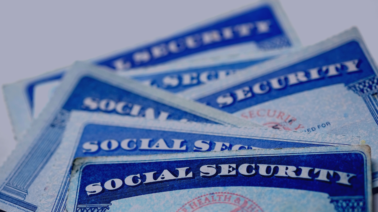 six social security cards stacked together