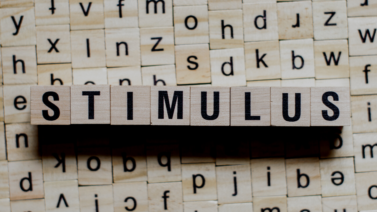 the word "stimulus" spelled out on wooden blocks with black lettering