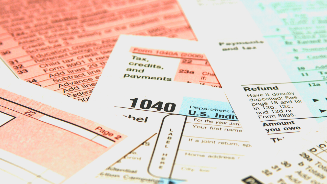 IRS tax return forms to submit for a refund spread out into a pile