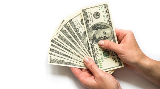 stimulus cash held in someone's hands