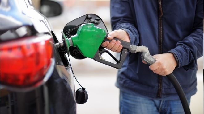 a car getting gas, which some Americans may soon see a stimulus payment for