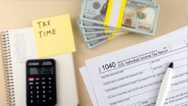 irs tax return form with cash representing a refund