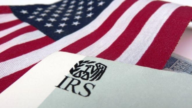 IRS paperwork on top of American flag 