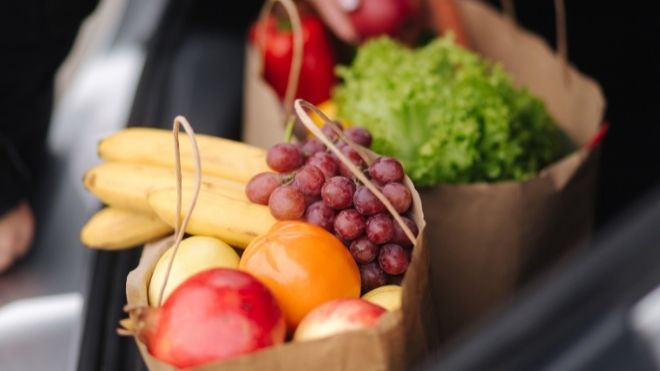 grocery bags filled with healthy foods