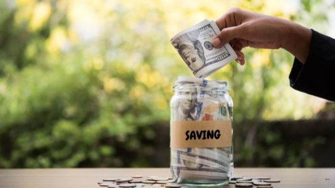putting money in savings jar