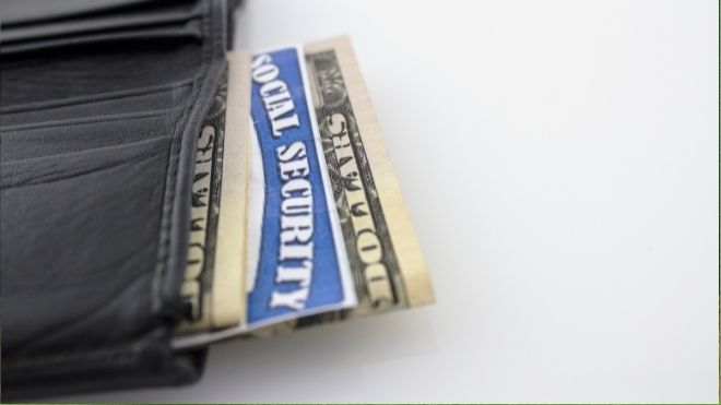 social security card with cash representing retirement benefits