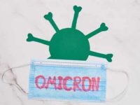 Omicron written on mask with virus