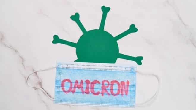 Omicron written on mask with virus