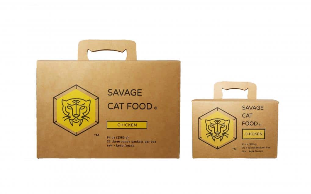 Two boxes of Savage Cat Food Chicken, one large (84 oz.) and one small (21 oz.), with lot code 11152026 visible on the packaging.