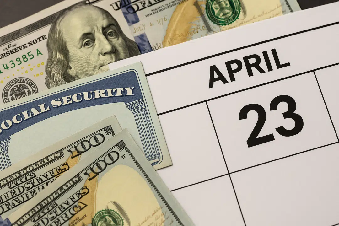 Social Security card, hundred-dollar bills, and April 23 on a calendar — symbolizing SSDI payments with COLA increase.