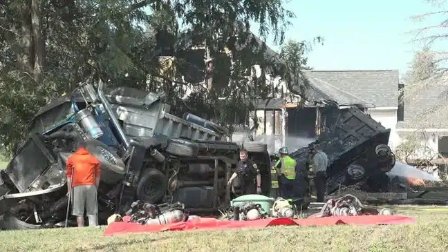Dump truck crashes into home, kills woman