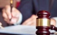 A judge's gavel in a courtroom setting