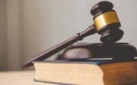 A judge's gavel in a courtroom setting