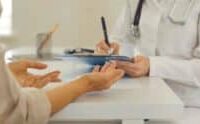 A doctor speaks with a patient during a consultation