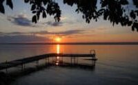 A dock extends into a Finger Lakes sunset
