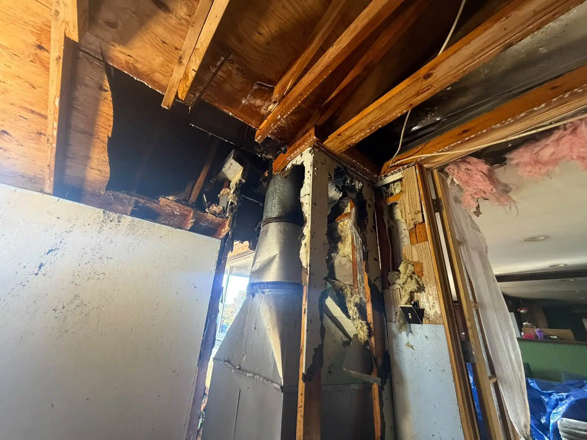 Opened walls and ceiling around a fireplace flue after the Fisher Road fire in Phelps.